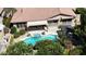 Aerial view of a private backyard oasis, featuring a pool, spa, pergola, and covered patio at 18575 E Pine Barrens Ave, Queen Creek, AZ 85142
