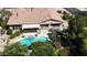Aerial view of a home with a backyard pool and spa with covered patio and lush landscaping at 18575 E Pine Barrens Ave, Queen Creek, AZ 85142