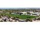 Aerial view of a community park with a school, athletic field, and mature trees at 18575 E Pine Barrens Ave, Queen Creek, AZ 85142