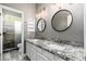 Updated bathroom featuring dual sinks, granite counters, and a large glass shower at 18575 E Pine Barrens Ave, Queen Creek, AZ 85142