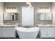 Bright bathroom featuring a freestanding tub, double sinks and modern fixtures at 18575 E Pine Barrens Ave, Queen Creek, AZ 85142
