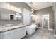 Luxury primary bathroom with a soaking tub, dual vanities, and a walk-in shower at 18575 E Pine Barrens Ave, Queen Creek, AZ 85142