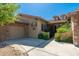 Exterior view showcasing a stone-accented home with a tile roof, desert landscaping, and a side-entry garage at 18575 E Pine Barrens Ave, Queen Creek, AZ 85142