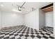 Clean garage features a black and white checkered floor and a new coat of paint at 18575 E Pine Barrens Ave, Queen Creek, AZ 85142