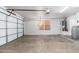 Spacious garage with concrete floors, a garage door, and utility hookups at 18575 E Pine Barrens Ave, Queen Creek, AZ 85142