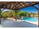 View of backyard gazebo, pool, fire pit, and lush landscaping perfect for outdoor entertaining at 18575 E Pine Barrens Ave, Queen Creek, AZ 85142