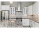 Close-up of a modern kitchen with white cabinetry, stainless steel appliances, and a granite countertop at 18575 E Pine Barrens Ave, Queen Creek, AZ 85142