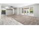 Spacious living room with neutral carpet, gray walls, white trim, and French doors leading to the backyard at 18575 E Pine Barrens Ave, Queen Creek, AZ 85142