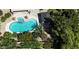 Aerial view of a backyard pool and spa featuring lush landscaping and a shaded pergola at 18575 E Pine Barrens Ave, Queen Creek, AZ 85142