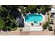 Aerial view of a backyard pool with jacuzzi, lush landscaping, and shaded pergola at 18575 E Pine Barrens Ave, Queen Creek, AZ 85142