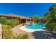 Inviting backyard showcasing a pristine pool, spa, gazebo, and well-maintained desert landscaping at 18575 E Pine Barrens Ave, Queen Creek, AZ 85142