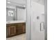 Bathroom featuring a glass door enclosed shower, double vanity sink, and neutral wall color at 21296 N 270Th Ln, Buckeye, AZ 85396