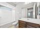 Well-lit bathroom featuring a tub, shower, vanity and toilet, offering a clean and functional design at 21296 N 270Th Ln, Buckeye, AZ 85396