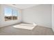 Bright bedroom featuring a large window offering plenty of natural light and neutral carpet at 21296 N 270Th Ln, Buckeye, AZ 85396
