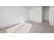 Neutral bedroom featuring neutral carpeting, paint and a door leading to the hallway at 21296 N 270Th Ln, Buckeye, AZ 85396