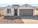 Charming single-story home featuring a stylish two-car garage and inviting front entrance at 21296 N 270Th Ln, Buckeye, AZ 85396
