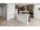 Spacious kitchen with a central island, dark cabinets, stainless steel appliances, and tile flooring at 21296 N 270Th Ln, Buckeye, AZ 85396