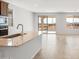 Kitchen with light-colored island, open layout, tile floors and lots of natural light at 21296 N 270Th Ln, Buckeye, AZ 85396