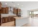 Kitchen featuring stainless steel appliances, dark wood cabinets, granite countertops, and a spacious island at 21296 N 270Th Ln, Buckeye, AZ 85396