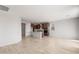 Open-concept living area with tile flooring extending into the kitchen with a large island at 21296 N 270Th Ln, Buckeye, AZ 85396