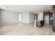 Open-concept living area with tile flooring that flows into the adjacent kitchen area at 21296 N 270Th Ln, Buckeye, AZ 85396