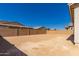 Expansive backyard enclosed by a brick wall, offers privacy and a blank canvas for personalized landscaping at 21830 E Bonanza E Ct, Queen Creek, AZ 85142