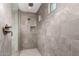 Modern shower with gray tile surround, rainfall showerhead, and recessed niche at 21830 E Bonanza E Ct, Queen Creek, AZ 85142