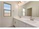 Bright bathroom features double sinks, white cabinetry, and a large mirror at 21830 E Bonanza E Ct, Queen Creek, AZ 85142