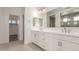 Bathroom with double sink vanity, white cabinets, and a view of the walk-in shower at 21830 E Bonanza E Ct, Queen Creek, AZ 85142