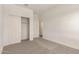 This bedroom has neutral carpet and trim, plus a closet for storage at 21830 E Bonanza E Ct, Queen Creek, AZ 85142
