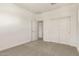 A standard bedroom boasts neutral carpet, white walls and trim, plus a closet at 21830 E Bonanza E Ct, Queen Creek, AZ 85142