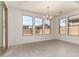 Bright dining room featuring tile floors, a chandelier, and a trio of windows at 21830 E Bonanza E Ct, Queen Creek, AZ 85142