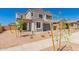 Inviting home featuring a manicured front yard, two-car garage, and tasteful desert landscaping at 21830 E Bonanza E Ct, Queen Creek, AZ 85142