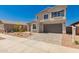Charming two-story home showcasing a neat front yard, paved driveway, and a neutral color scheme at 21830 E Bonanza E Ct, Queen Creek, AZ 85142