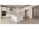 Spacious white kitchen featuring stainless appliances, an island with a sink, and tile flooring at 21830 E Bonanza E Ct, Queen Creek, AZ 85142