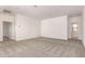 An expansive living room offers neutral carpet, bright white walls, and recessed lighting at 21830 E Bonanza E Ct, Queen Creek, AZ 85142