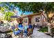 Backyard patio featuring pool, outdoor dining set, and mature tree at 2226 E Beachcomber Dr, Gilbert, AZ 85234
