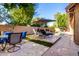 Backyard with pool, lounge chairs, and outdoor dining area with a nearby barbecue at 2226 E Beachcomber Dr, Gilbert, AZ 85234