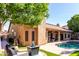 Backyard featuring a pool, patio, and artificial turf landscaping at 2226 E Beachcomber Dr, Gilbert, AZ 85234
