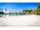 Sandy community beach area featuring a volleyball court and lounging chairs, perfect for lakeside fun at 2226 E Beachcomber Dr, Gilbert, AZ 85234