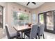 Bright dining room with a large window and a glass topped table is perfect for entertaining at 2226 E Beachcomber Dr, Gilbert, AZ 85234