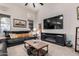 Inviting living room with a plush sofa, ceiling fan and entertainment center at 2226 E Beachcomber Dr, Gilbert, AZ 85234