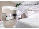 Spacious bedroom featuring a charming canopy bed and elegant chandelier lighting at 2226 E Beachcomber Dr, Gilbert, AZ 85234