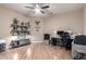 Inviting office space with wood floors, ceiling fan, and built-in shelving with decor at 2226 E Beachcomber Dr, Gilbert, AZ 85234