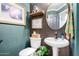 Charming powder room with unique wallpaper, decorative mirror, and updated fixtures at 2226 E Beachcomber Dr, Gilbert, AZ 85234