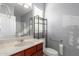 Functional bathroom featuring a single sink vanity, toilet, and walk-in shower with accessible grab bars at 240 N Monterey Ct, Casa Grande, AZ 85194