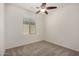 Bright bedroom with neutral carpet, ceiling fan, and a window with natural light at 240 N Monterey Ct, Casa Grande, AZ 85194