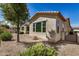 A charming single-story home featuring stucco siding, a terracotta roof, and a beautifully landscaped gravel yard at 240 N Monterey Ct, Casa Grande, AZ 85194