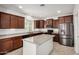 Modern kitchen featuring a large island, stainless steel appliances, and sleek dark wood cabinetry at 240 N Monterey Ct, Casa Grande, AZ 85194