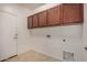 Laundry room with tile flooring, cabinets, and hookups for washer and dryer at 240 N Monterey Ct, Casa Grande, AZ 85194